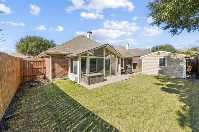 a view of a house with backyard and sitting area