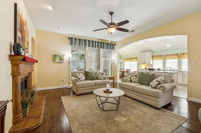 a living room with furniture a fireplace and a flat screen tv