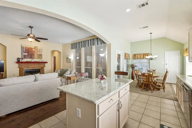 a living room with fireplace furniture and a chandelier