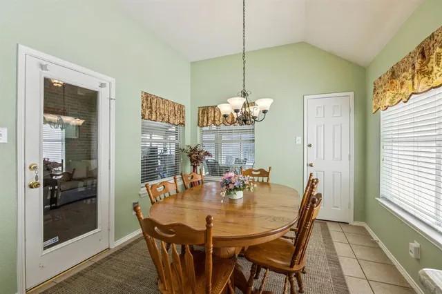 a view of a dining room with furniture wooden floor and chandelier