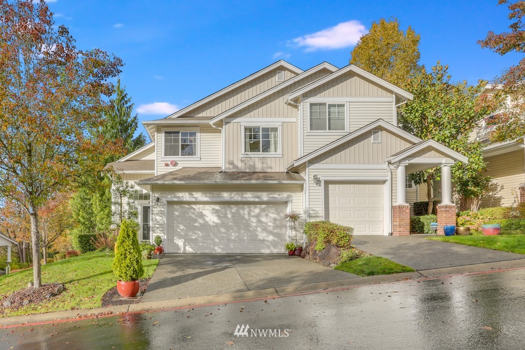 102 South 49th Street, Unit A Renton, WA 98055 - Photo 1 of 35 a view of a white house with a yard and large tree