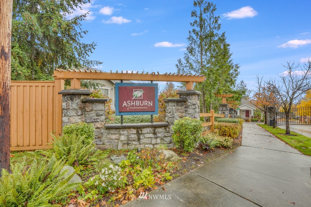 102 South 49th Street, Unit A Renton, WA 98055 - Photo 2 of 35 a sign that is sitting in front of flowers