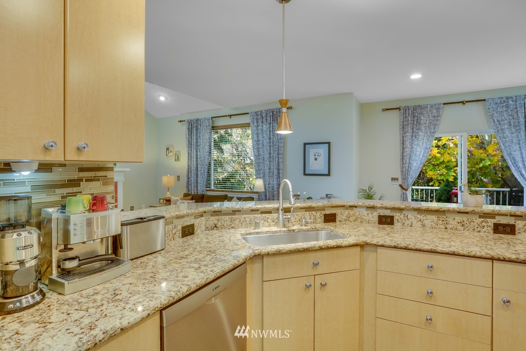 102 South 49th Street, Unit A Renton, WA 98055 - Photo 15 of 35 a kitchen with sink stove and cabinets