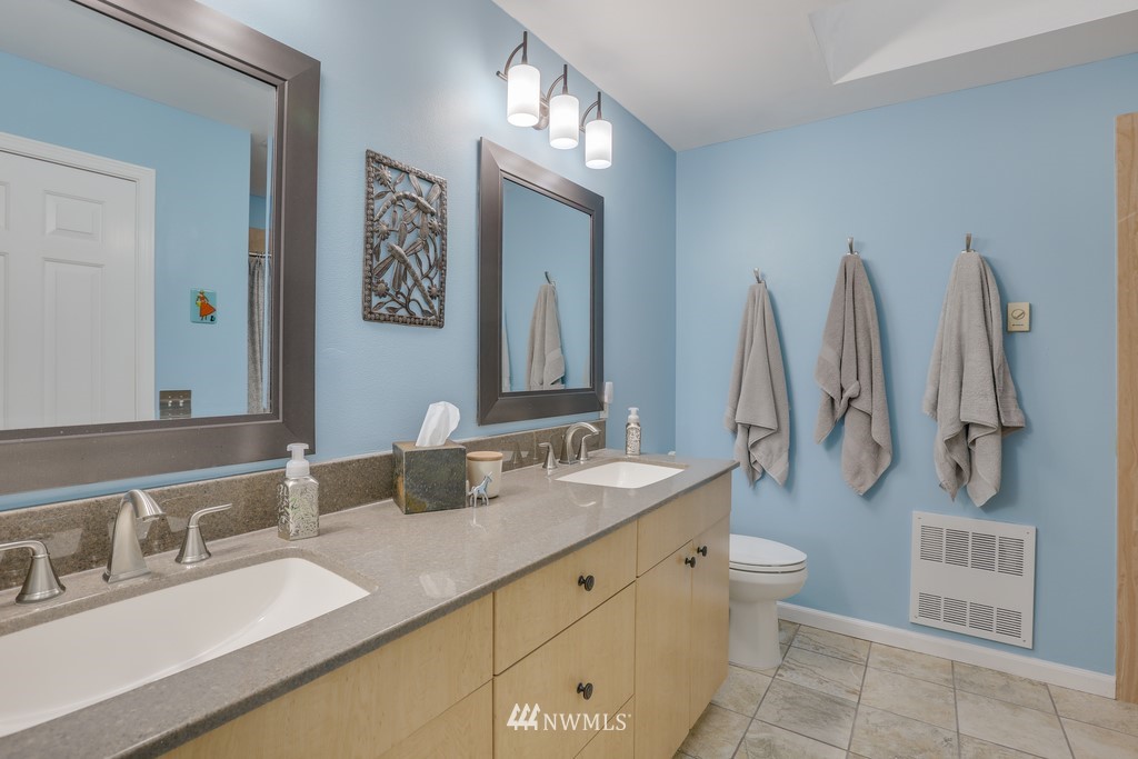 102 South 49th Street, Unit A Renton, WA 98055 - Photo 20 of 35 a bathroom with a double vanity sink and a mirror