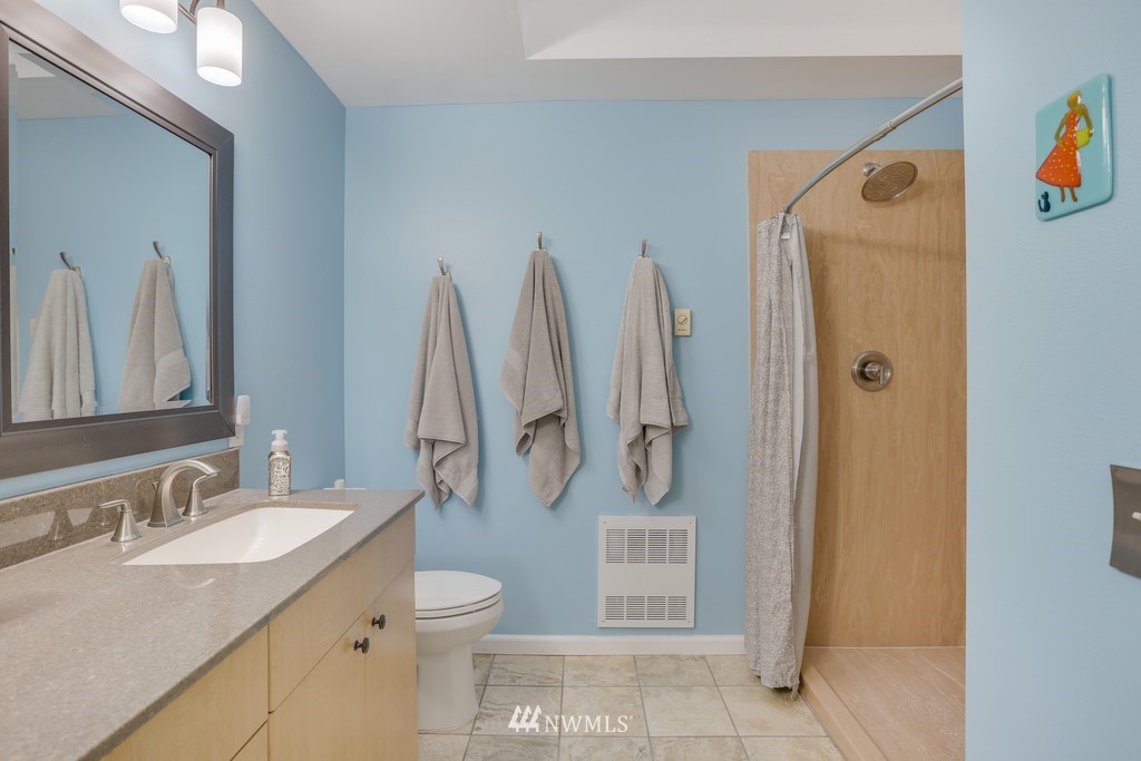102 South 49th Street, Unit A Renton, WA 98055 - Photo 21 of 35 a bathroom with a granite countertop sink toilet and shower