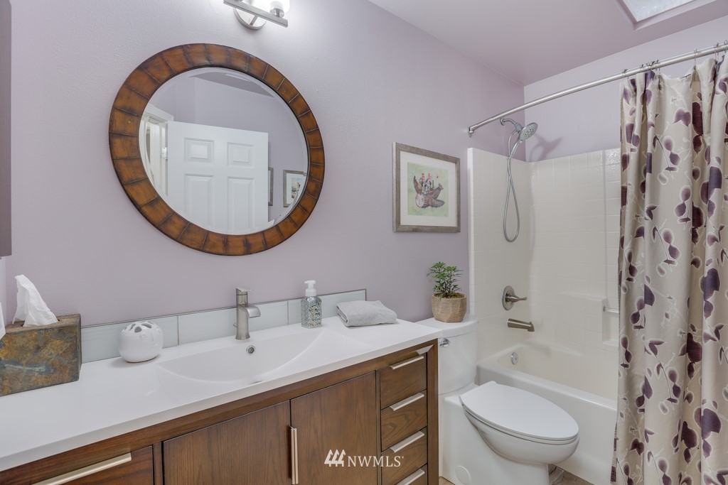 102 South 49th Street, Unit A Renton, WA 98055 - Photo 24 of 35 a bathroom with a sink a toilet and a mirror