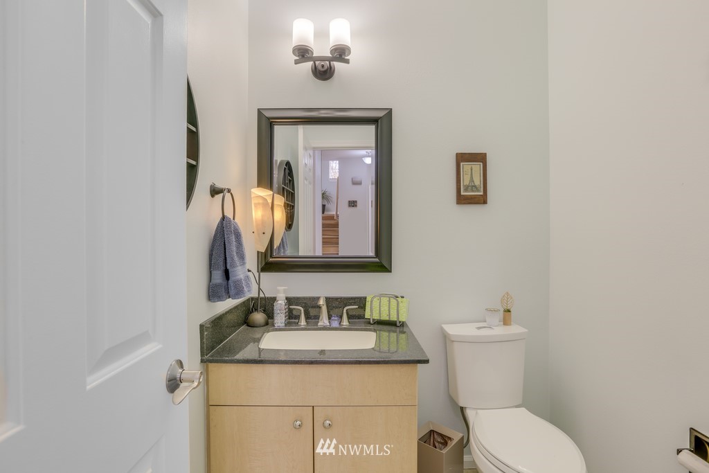 102 South 49th Street, Unit A Renton, WA 98055 - Photo 26 of 35 a bathroom with a granite countertop sink and a toilet