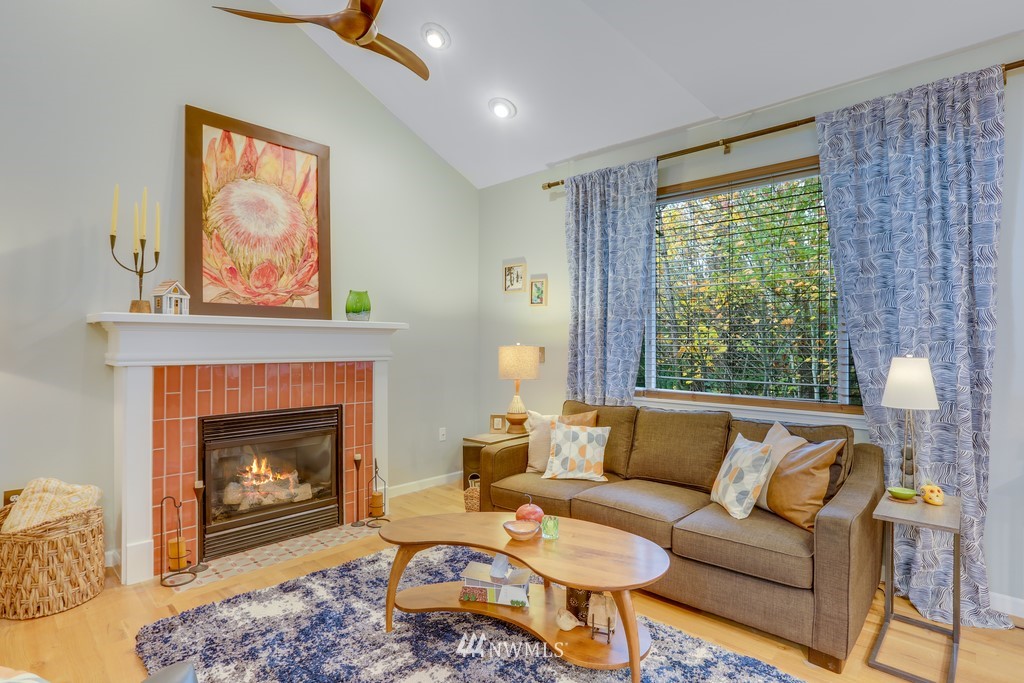 102 South 49th Street, Unit A Renton, WA 98055 - Photo 9 of 35 a living room with furniture a window and a fireplace