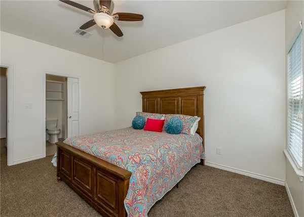 a bedroom with a bed and window