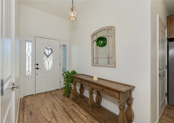 a view of an entryway with wooden floor