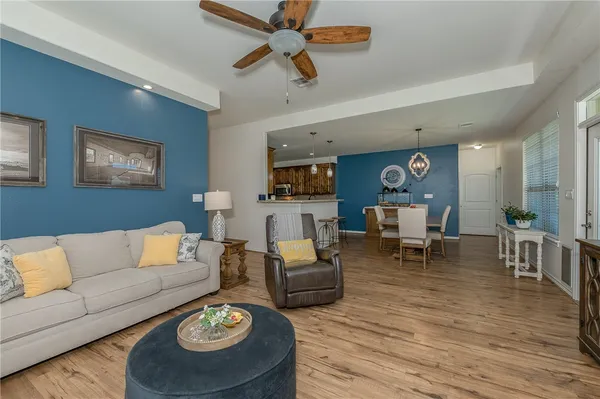 a living room with furniture and a wooden floor