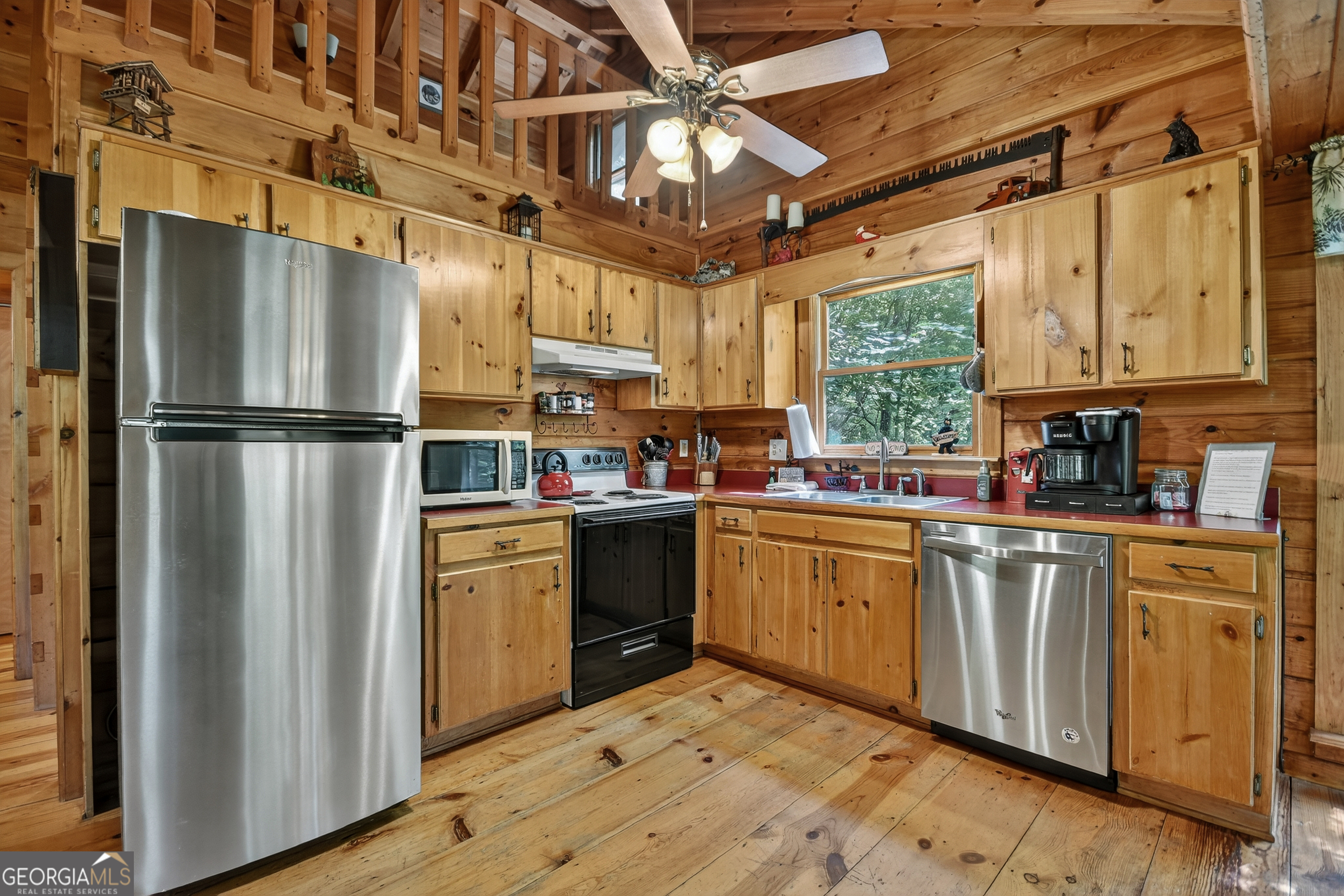 135 Tomahawk Trail Blue Ridge, GA 30513 - Photo 12 of 54 a kitchen with cabinets a window and stainless steel appliances