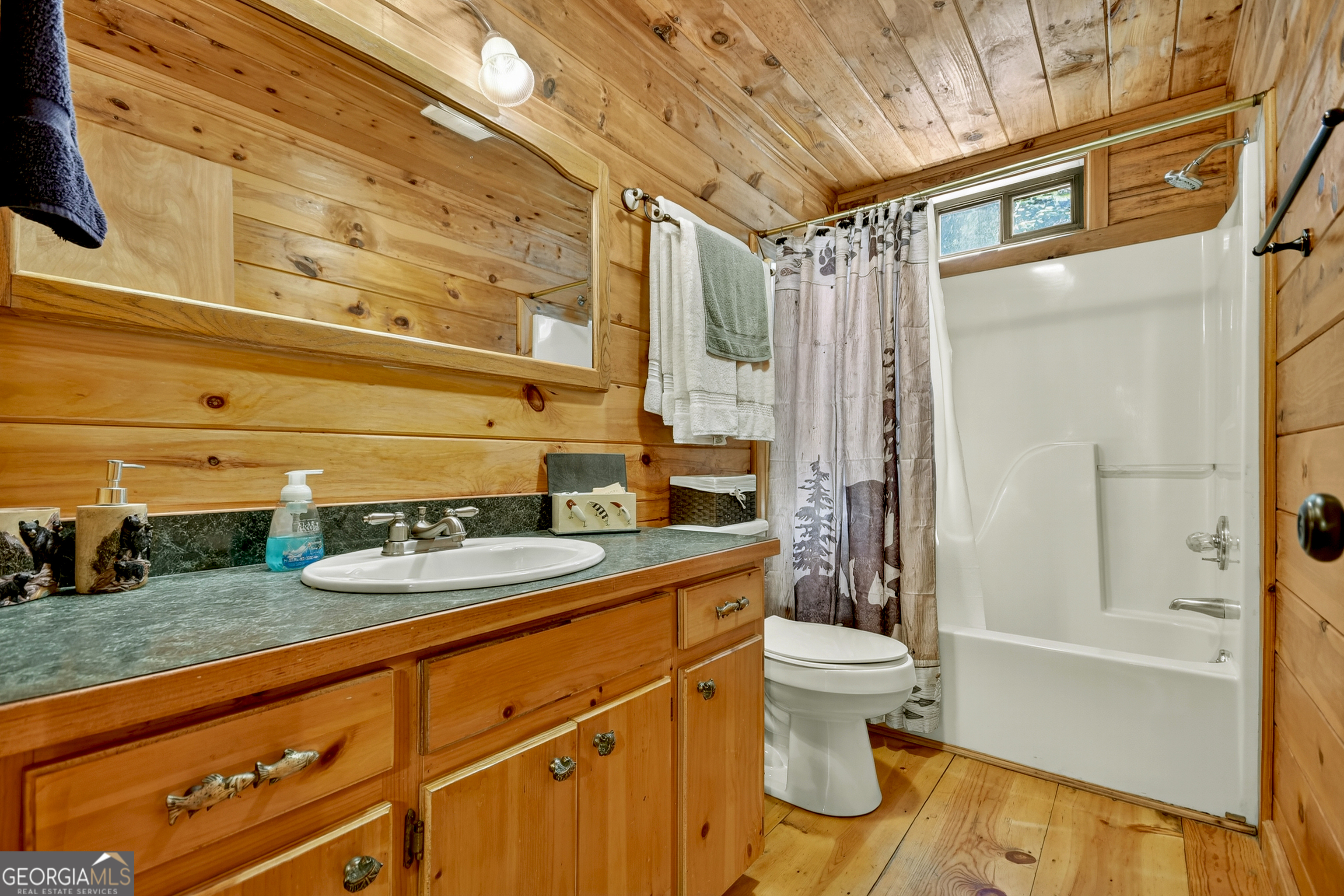 135 Tomahawk Trail Blue Ridge, GA 30513 - Photo 15 of 54 a bathroom with a granite countertop sink toilet and shower