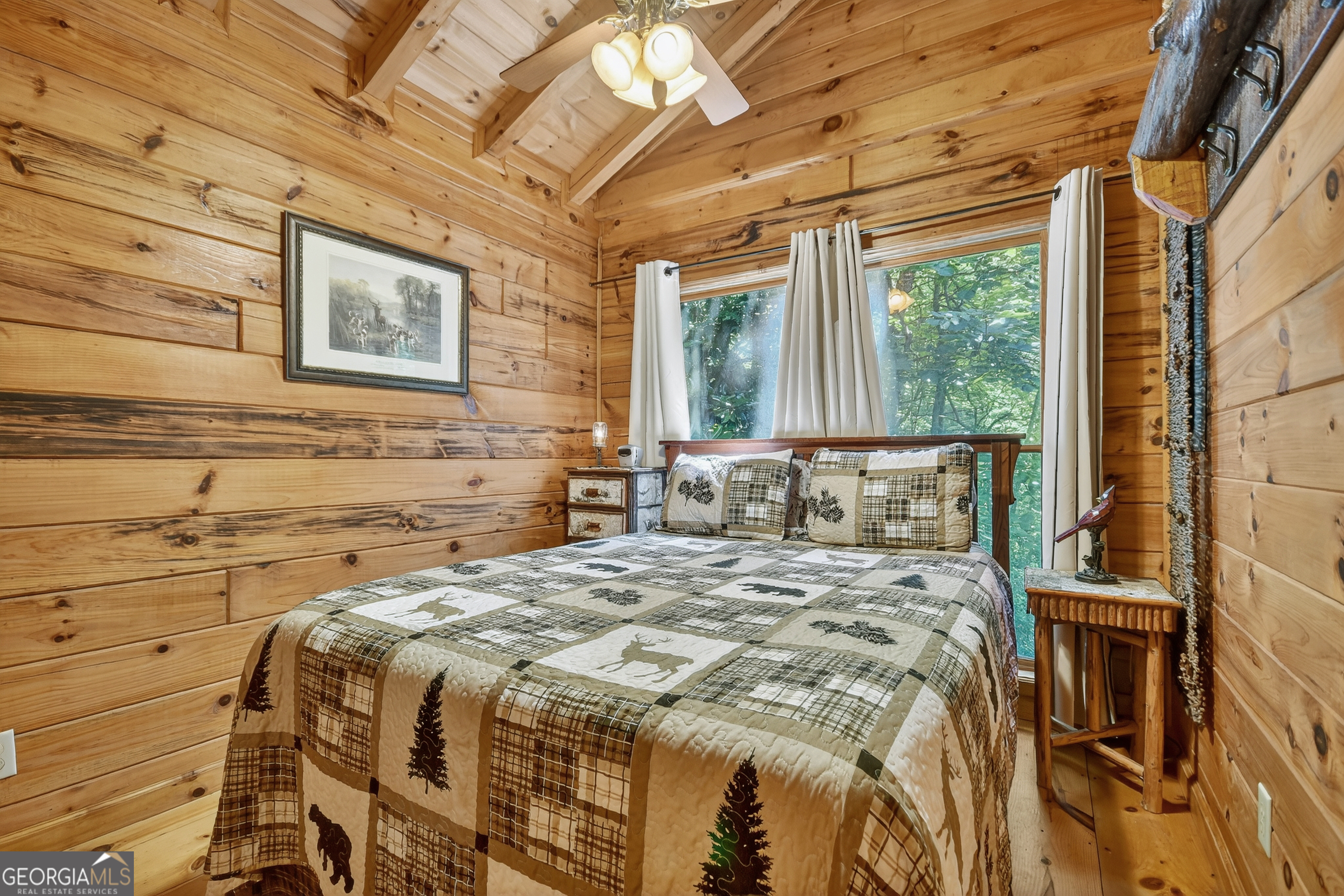135 Tomahawk Trail Blue Ridge, GA 30513 - Photo 16 of 54 a bed sitting in a bedroom next to a window