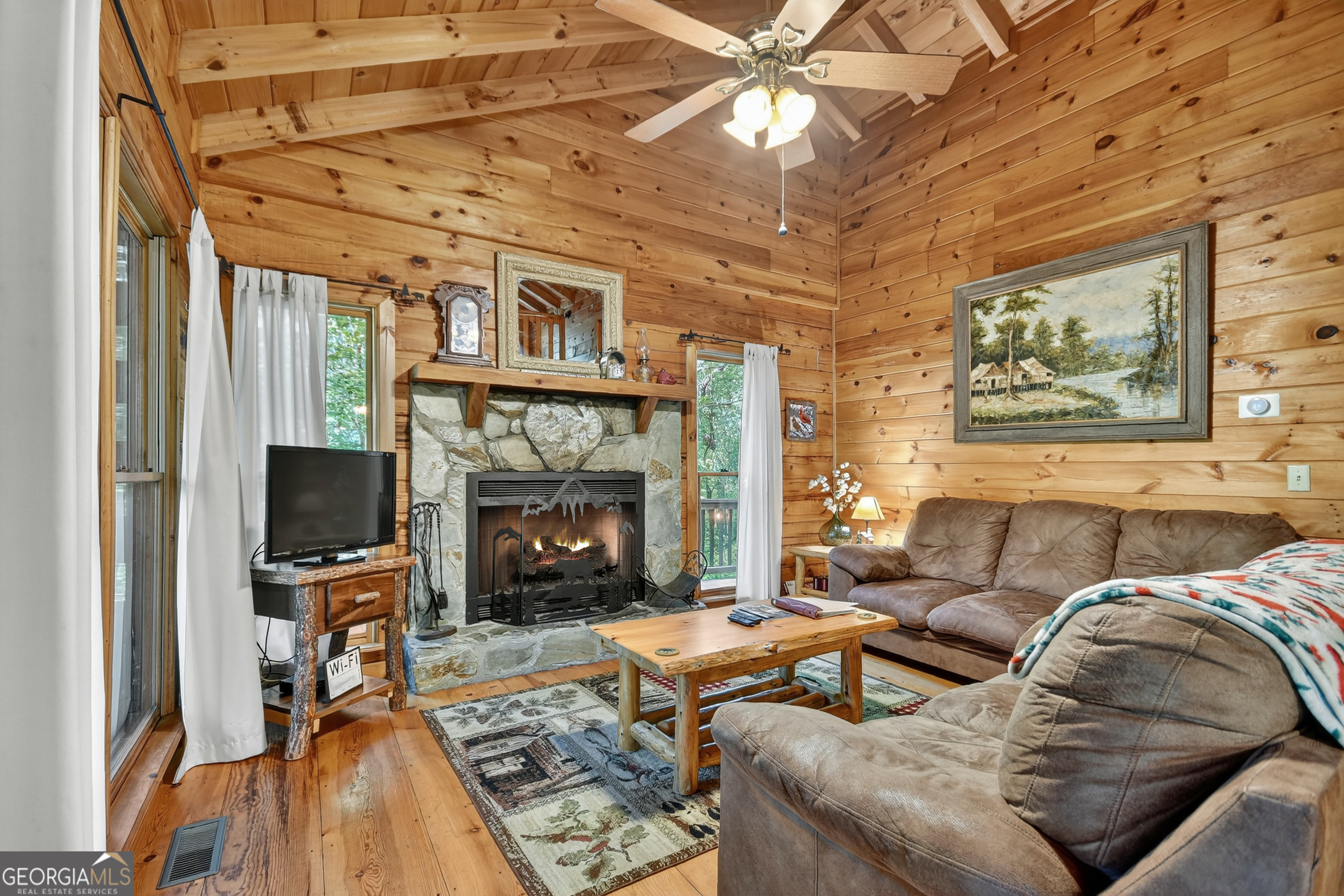 135 Tomahawk Trail Blue Ridge, GA 30513 - Photo 2 of 54 a living room with furniture a flat screen tv and a fireplace