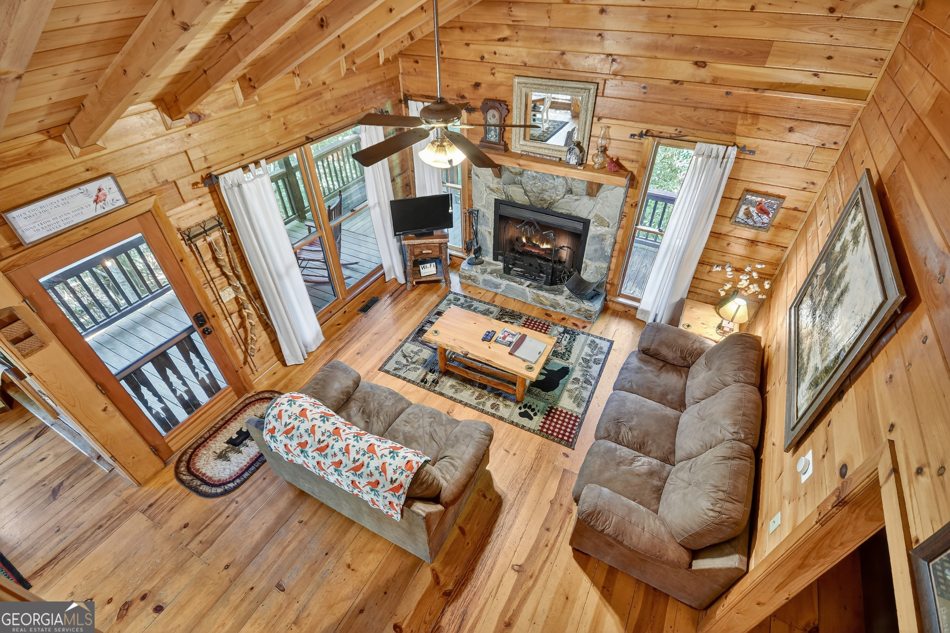 135 Tomahawk Trail Blue Ridge, GA 30513 - Photo 21 of 54 a living room with furniture a fireplace and a flat screen tv