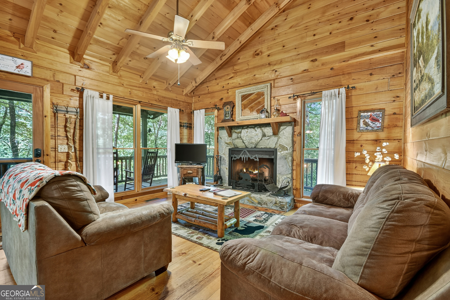 135 Tomahawk Trail Blue Ridge, GA 30513 - Photo 27 of 54 a living room with furniture fireplace and a large window
