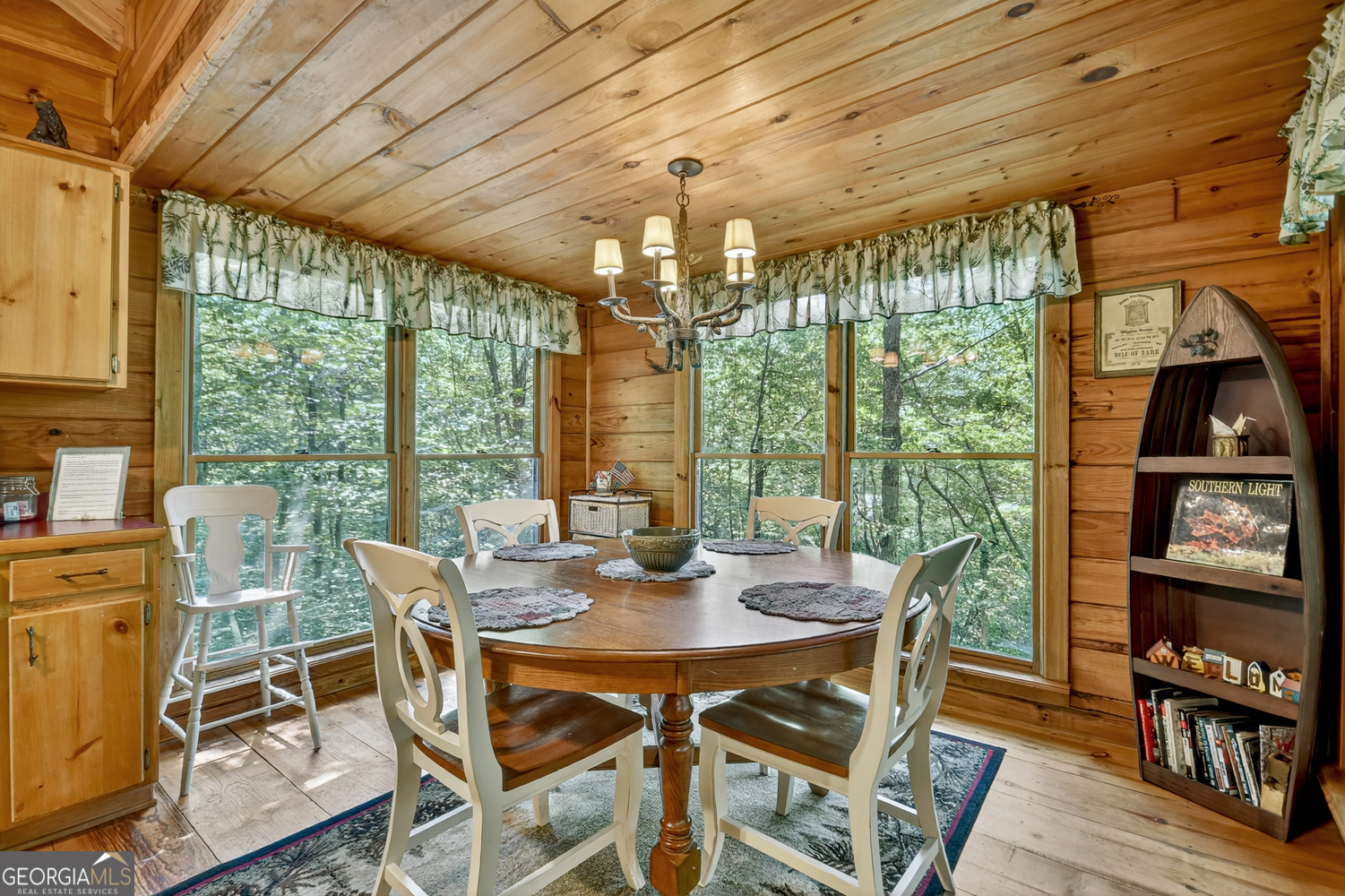 135 Tomahawk Trail Blue Ridge, GA 30513 - Photo 28 of 54 a view of a dining room with furniture large windows and wooden floor