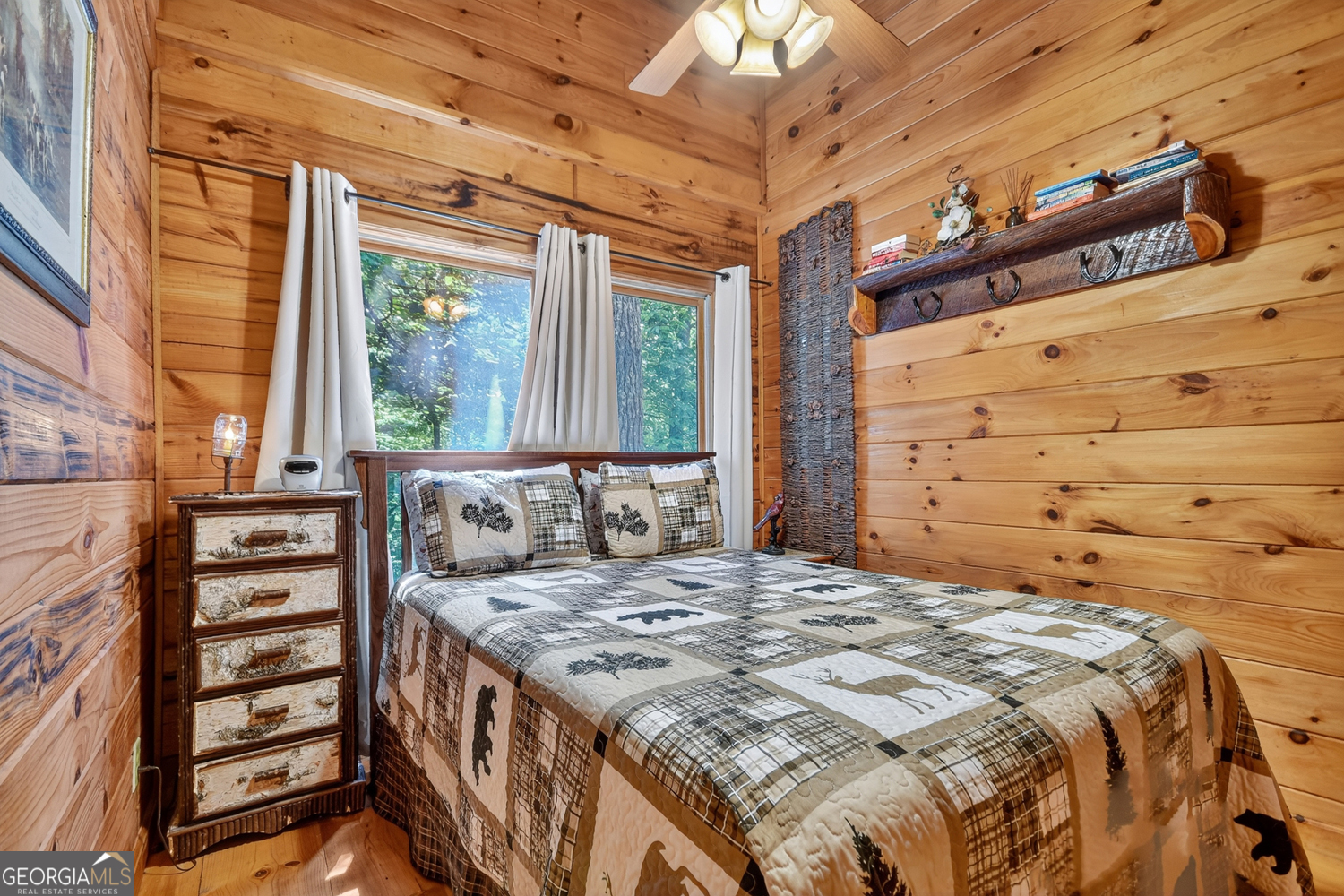 135 Tomahawk Trail Blue Ridge, GA 30513 - Photo 36 of 54 a large bed sitting in a bedroom next to a window