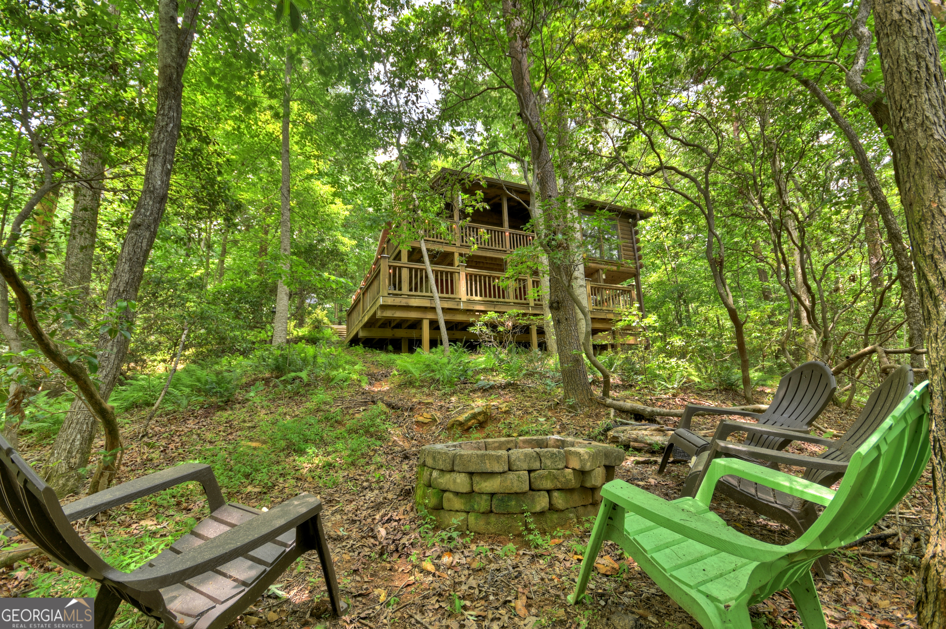 135 Tomahawk Trail Blue Ridge, GA 30513 - Photo 9 of 54 a view of an chairs and tables in the backyard