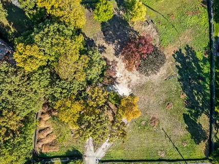 a big yard with lots of green space and trampoline