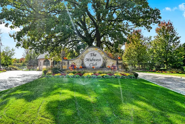 a view of yard with seating area and trees around