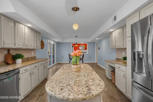 a kitchen with a sink cabinets and stainless steel appliances