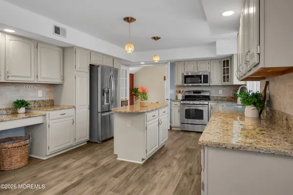 a bathroom with a granite countertop toilet sink and mirror