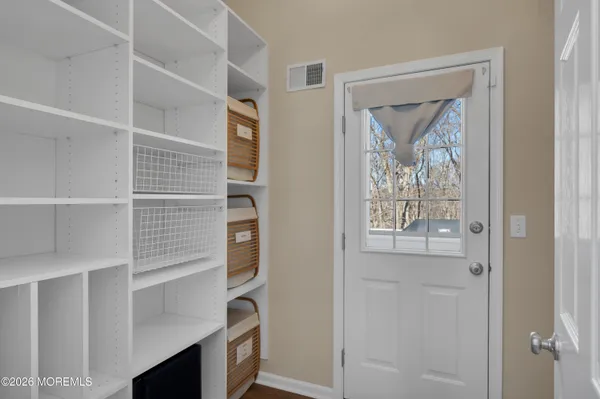a dining room with furniture a chandelier and wooden floor