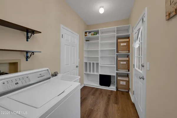 a dining room with furniture a chandelier and wooden floor