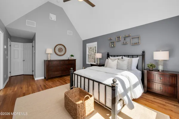 a bedroom with a bed and a potted plant