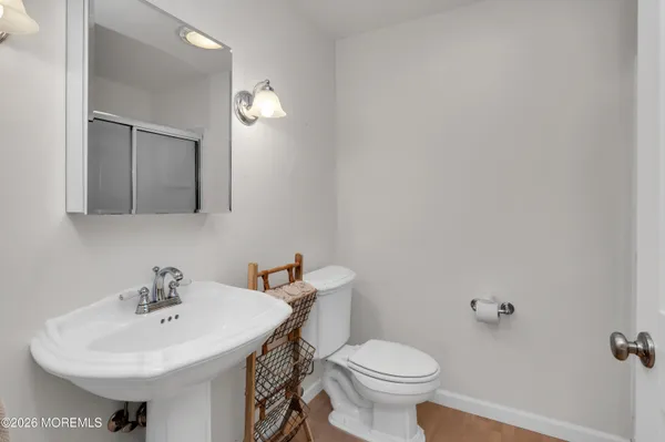 a front view of a house with a yard and a large tree