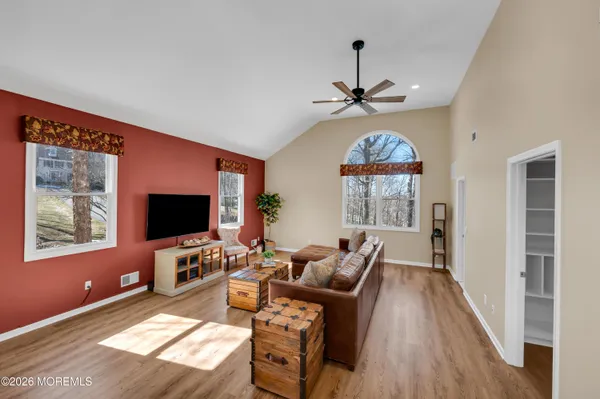 a living room with furniture a fireplace and a flat screen tv