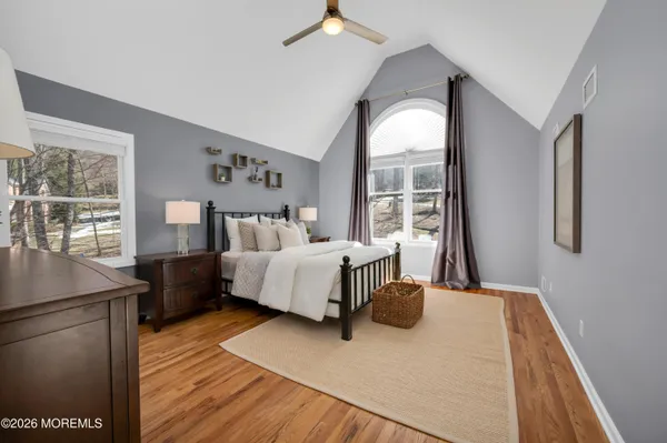 a bedroom with a bed and wooden floor