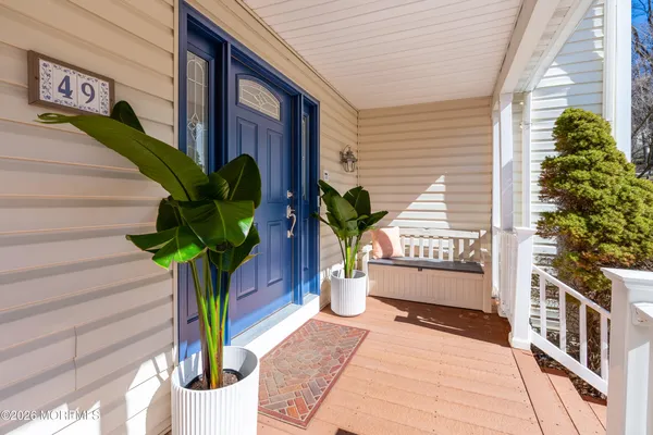 a vase with flowers sitting on a floor