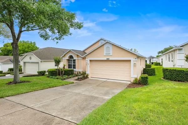 a front view of a house with a yard and garage