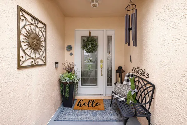 a kitchen with stainless steel appliances kitchen island granite countertop a table chairs and a refrigerator