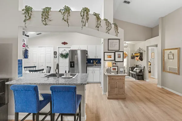a living room with furniture a flat screen tv and wooden floor