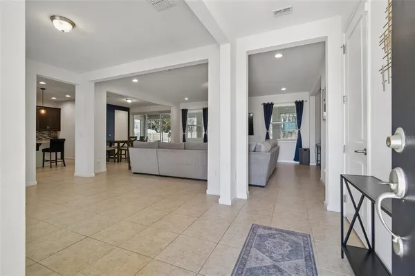 a living room with furniture and view of kitchen