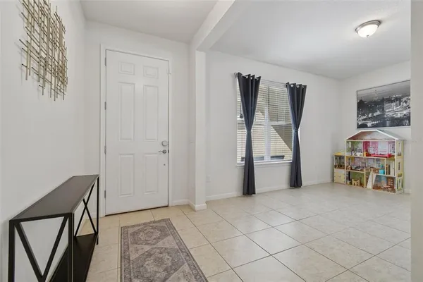 a kitchen with granite countertop a refrigerator a stove a sink dishwasher with a dining table and chairs