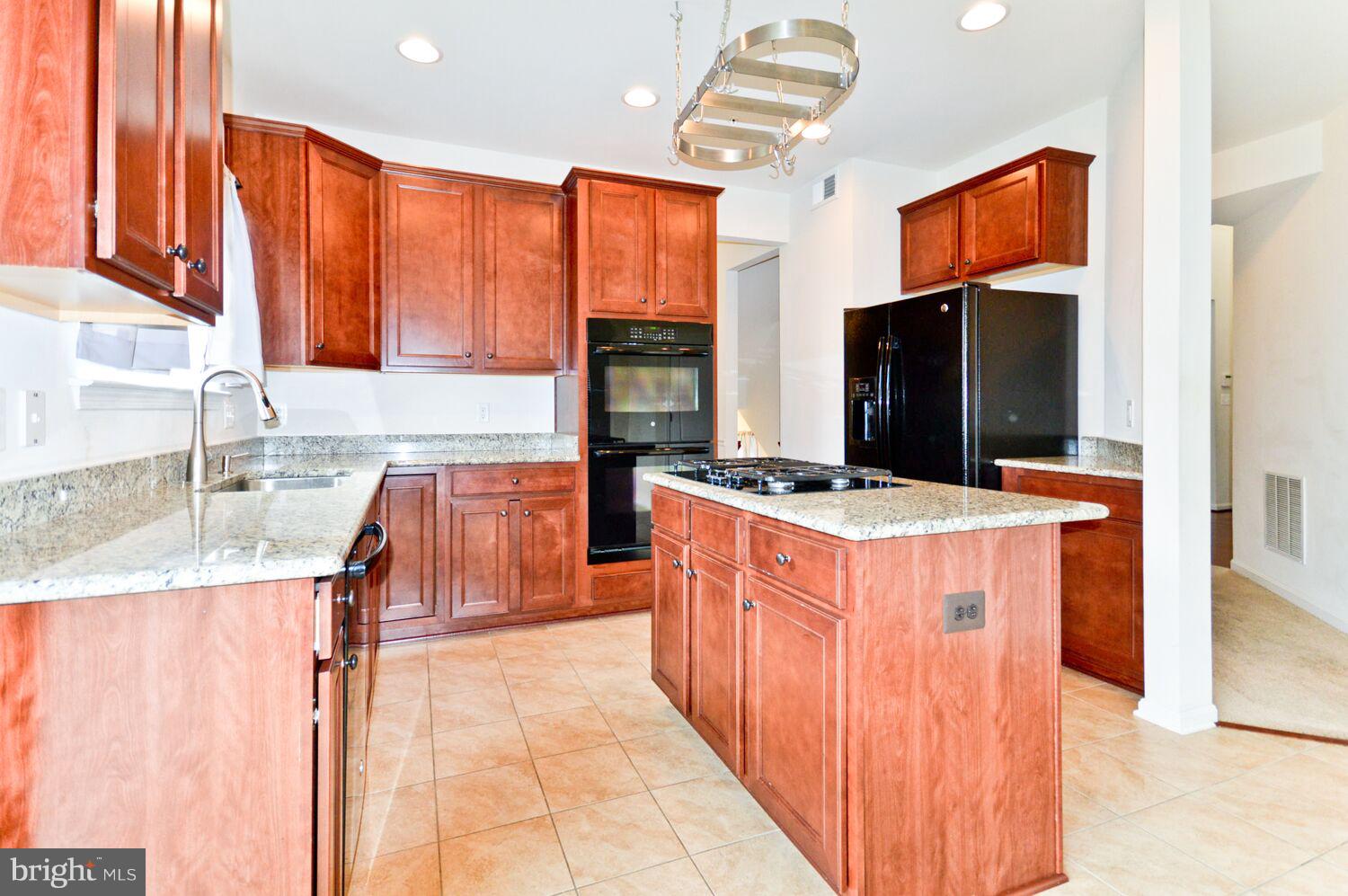 7110 Battle Field Loop Brandywine, MD 20613 - Photo 8 of 27 Kitchen w/ granite counters and gourmet appliances
