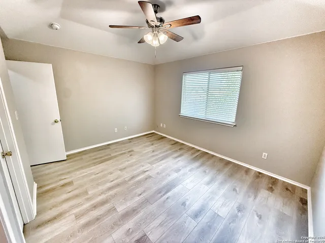 wooden floor in an empty room with a window