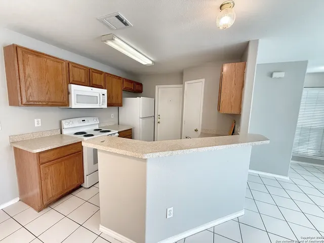 a kitchen with a stove a sink and a refrigerator