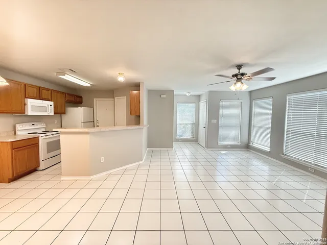 a view of a kitchen with a sink and a stove top oven
