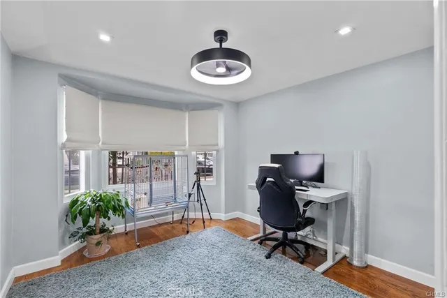 a view of a workspace with furniture and a potted plant