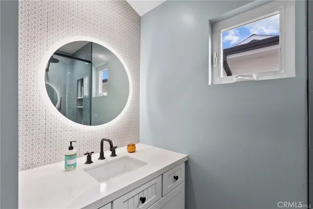 a bathroom with a sink and a mirror