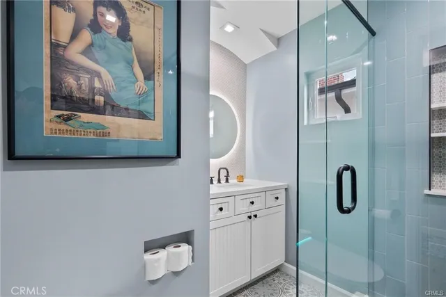 a bathroom with a sink mirror and vanity