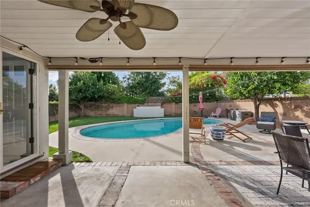 a view of a porch with furniture and a yard
