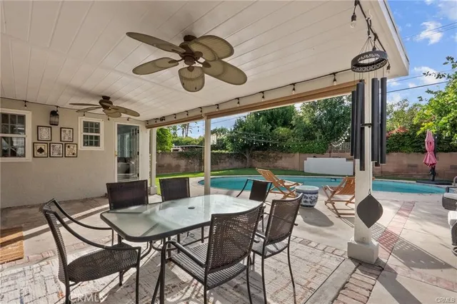 a view of a patio with a dining table and chairs
