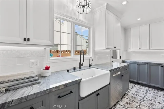 a kitchen that has a sink and a stove